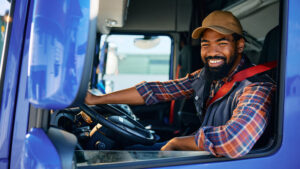 Happy man behind the wheel of a semi truck